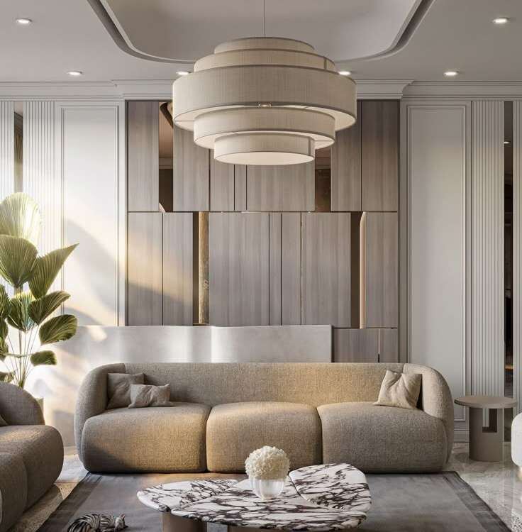 Living room with a tiered pendant, fluted wall panels and a curved sofa
