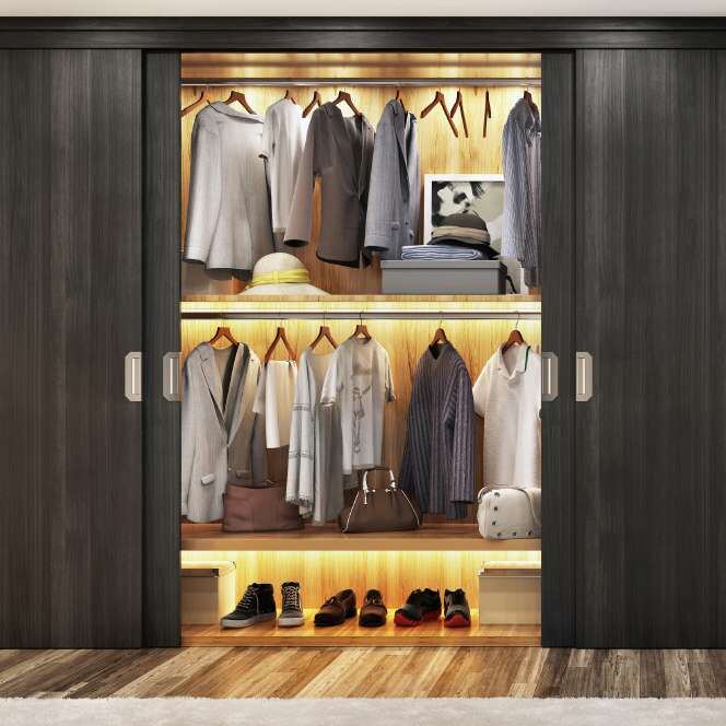 Dark sliding wardrobe with lit interior